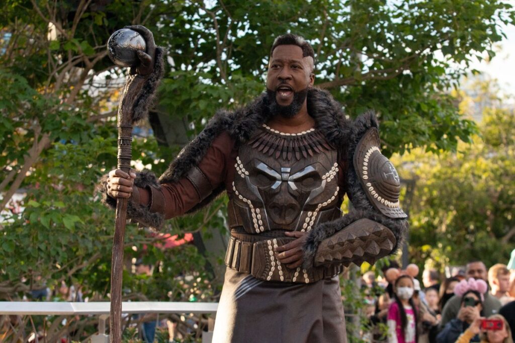 O Novo Pantera Negra e M'Baku caminham pelas ruas do campus dos Vingadores da Disney 25